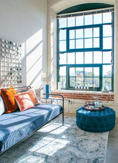 Large windows provide ample light in this loft living space at Lofts at Riverwalk in Columbus, Georgia