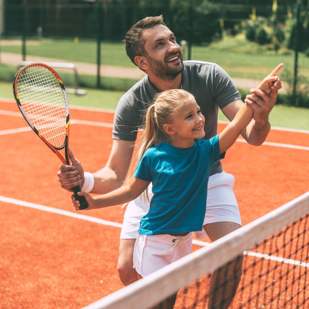 Father and daughter playing tennis at Westpark Club in Athens, Georgia