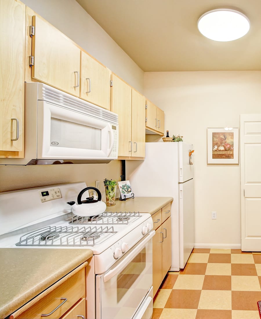 Beautiful white appliances with a stainless-steal sink at Laguna Creek Apartments in Elk Grove, California