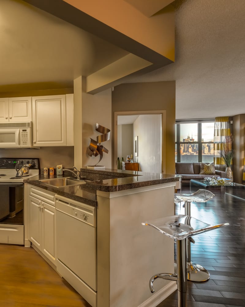 Model kitchen with bar seating at Riverbend at Port Imperial in West New York, New Jersey