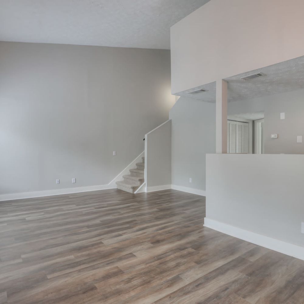 Unfurnished living room with wooden flooring at Village Lake Townhomes in Smyrna, Tennessee