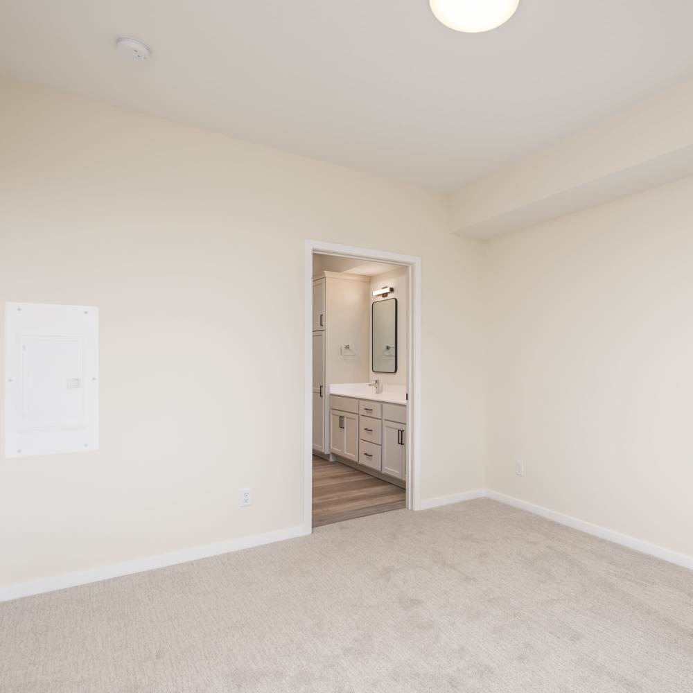 Bedroom with attached bathroom at The Uptown Apartments in Waconia, Minnesota