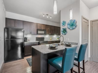 Gourmet kitchen with granite countertops and island at The Residences at Panther Hollow in Marble Falls, Texas