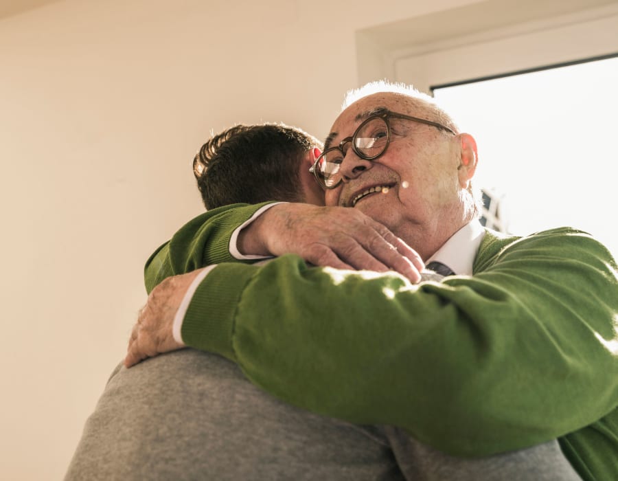 Resident hugging his son at Innovation Senior Living in Winter Park, Florida