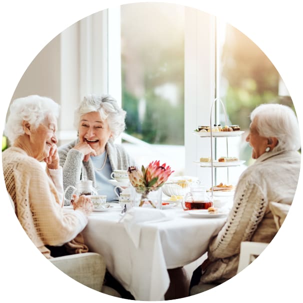 Residents sitting at a table eating at a Ebenezer Senior Living community