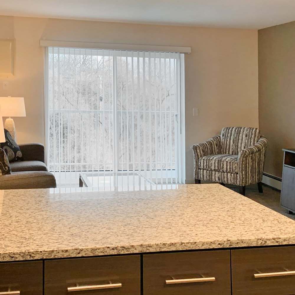 Living room with access to the private patio at Depot on Main in Zimmerman, Minnesota