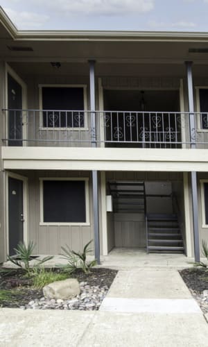 Exterior and building entrance at Franciscan Apartments in Garland, Texas