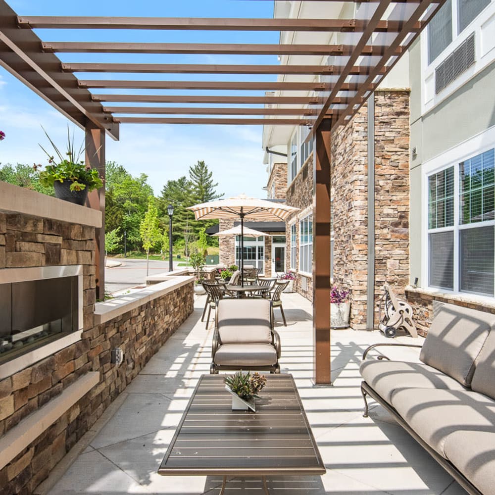 Outdoor seating area with fireplace at Anthology of Wildwood in Wildwood, Missouri