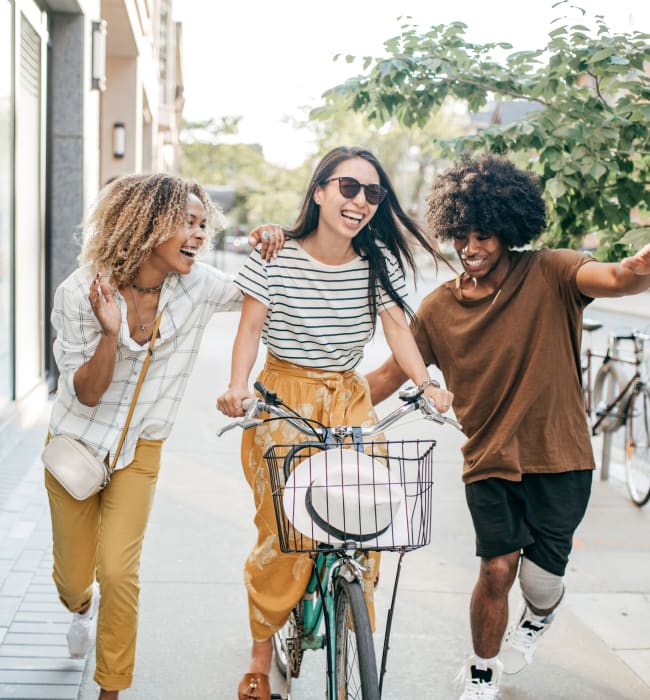 Resident on bike with friends running alongside near Marq Eight in Atlanta, Georgia