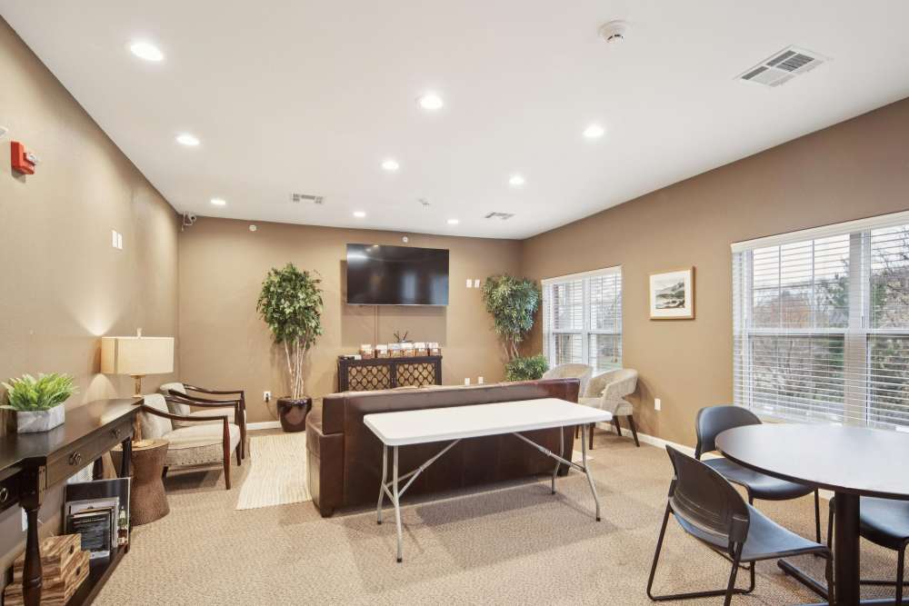 Bright communal lounge with comfortable seating and modern decor at Villas At Meadow Springs in Ankeny, Iowa