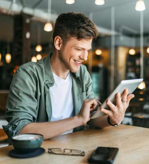 Resident using his ipad at a coffee shop near Dunbar Apartments in Lexington, North Carolina