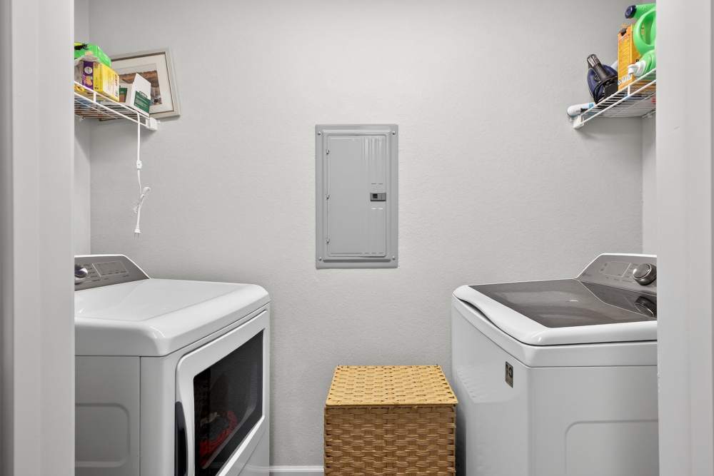 Bright and functional laundry room with modern appliances and clever storage solutions at Lakewood Crossing in Granbury, Texas.