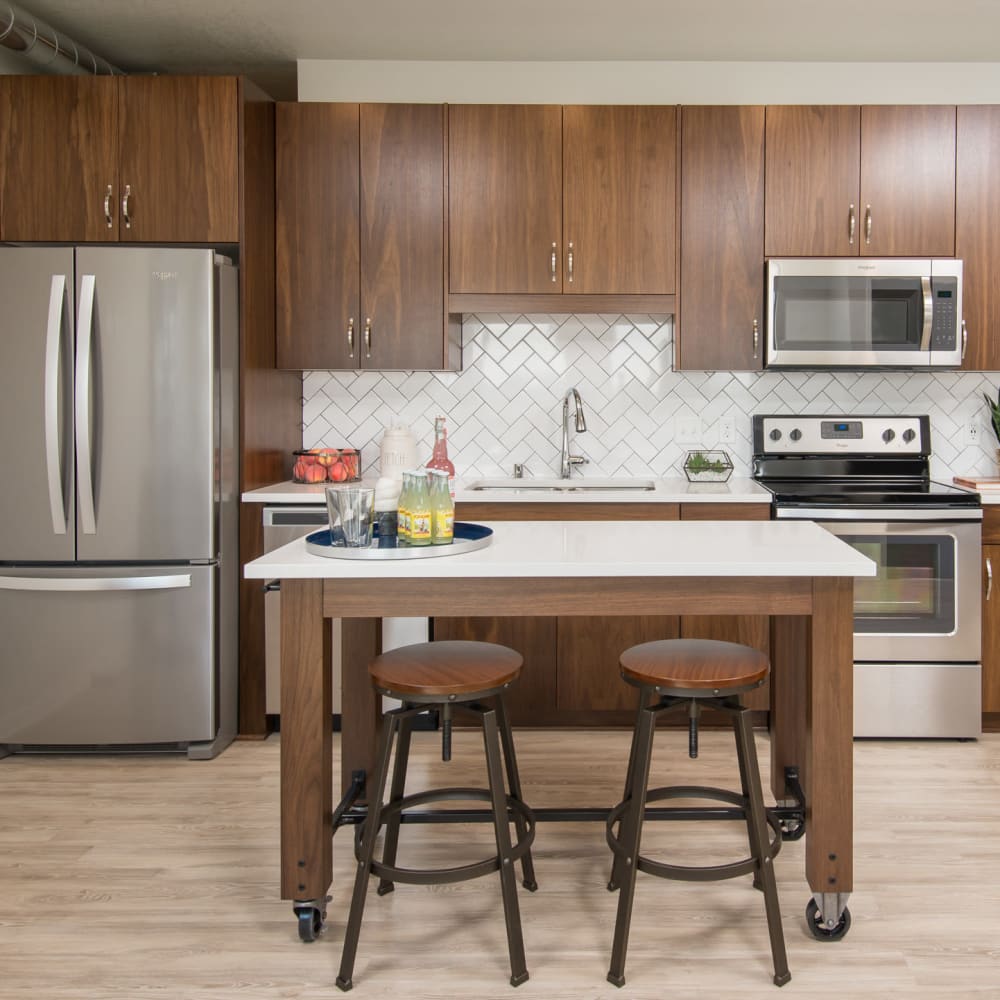 Quartz countertops and stainless-steel appliances in a model home's kitchen at Oaks Union Depot in St Paul, Minnesota