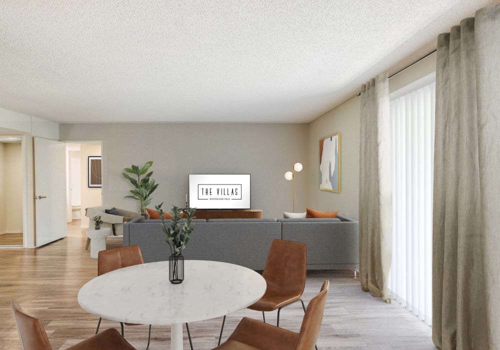 Cozy living room with natural light pouring in from the sliding-glass door at The Villas at Woodland Hills in Woodland Hills, California