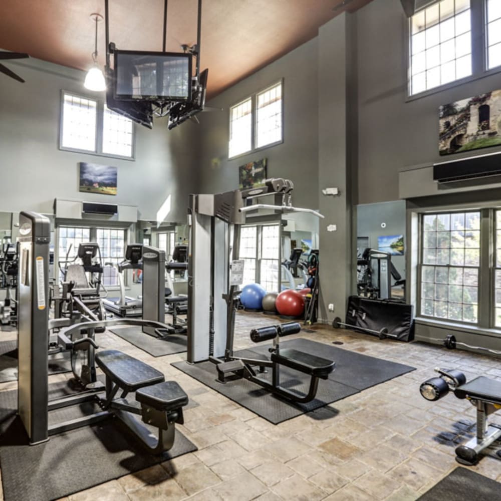 24-7 Fitness gym with air conditioning, tvs, free weights, and exercise machines at London House Apartments in Lenexa, Kansas