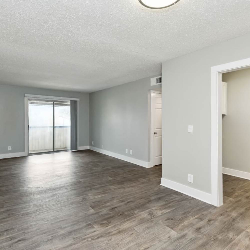 Living room with access to balcony at Meadow Glen Apartments in Springfield, Tennessee