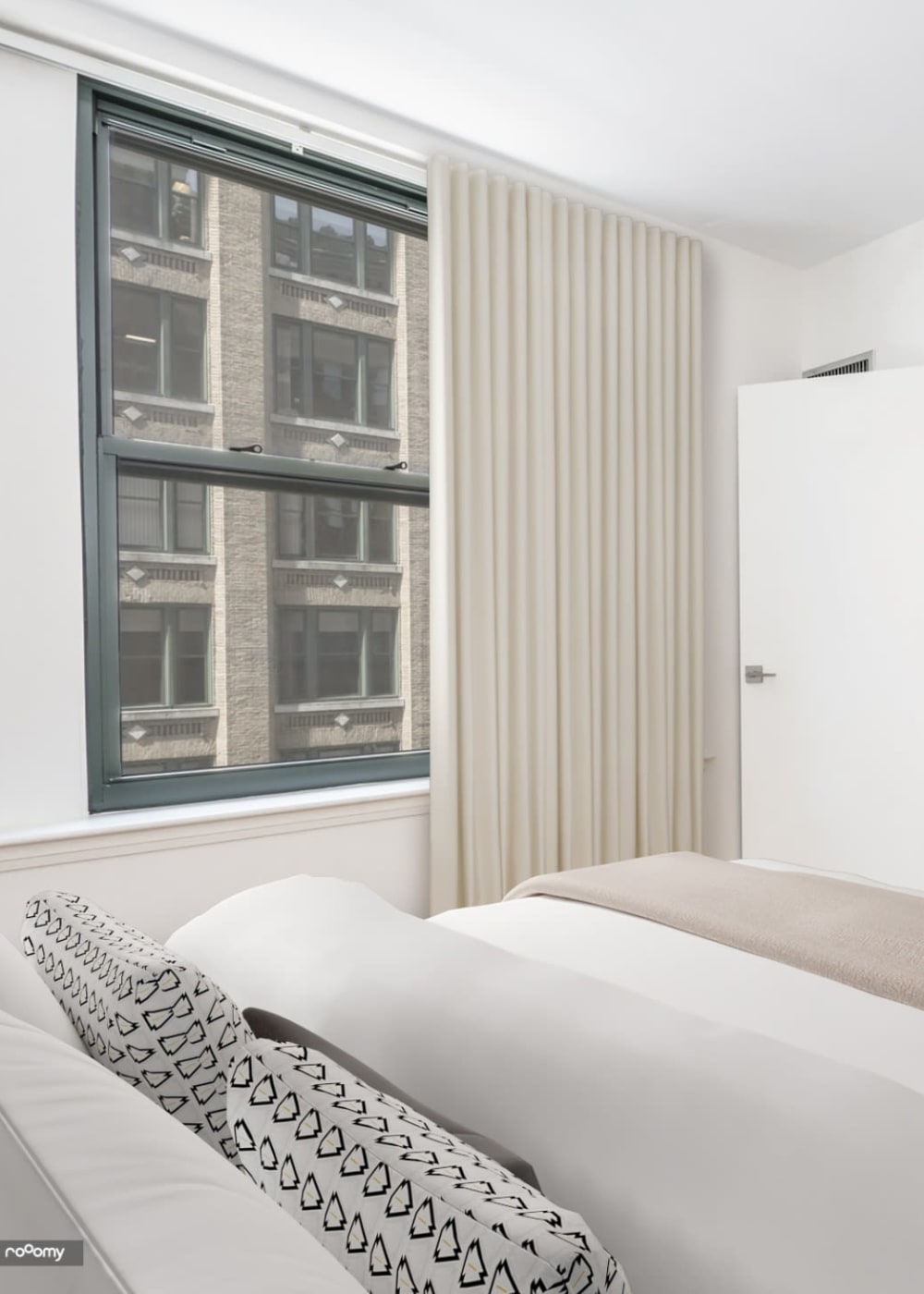 Bedroom rendering with closet and city views at One India Street Apartments in Boston, Massachusetts