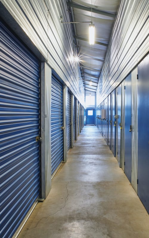 Interior storage units with blue doors at Sherlock Self Storage in Wilsonville, Oregon