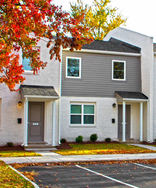 Apartment exterior view with street parking at Bell Diamond Manor in Norfolk, Virginia