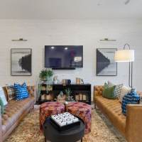 Stylish lounge area with leather sofas at The Reid in Tucker, Georgia