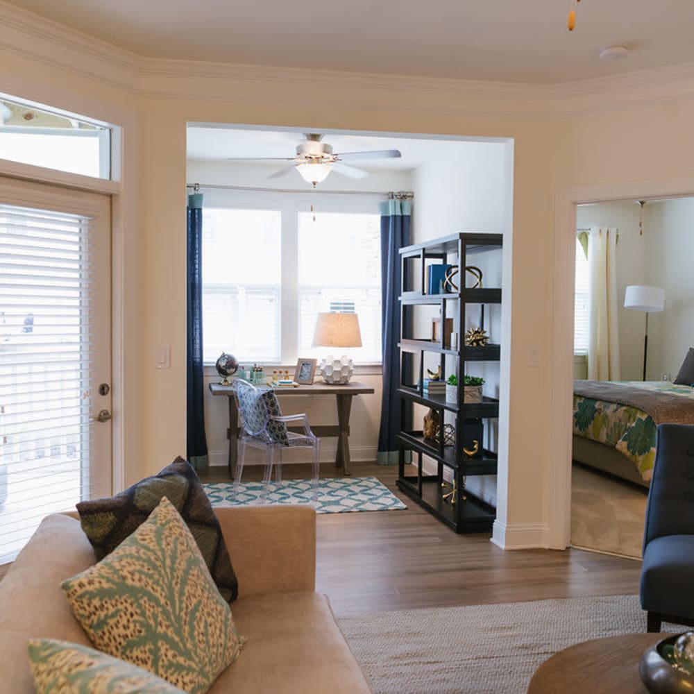 Living room and den with wood-style flooring at Beacon on 5th in Charlottesville, Virginia