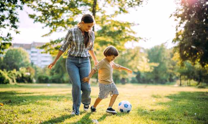Resident woman playing soccer with her daugther at The Heights at Happy Valley in Happy Valley, Oregon