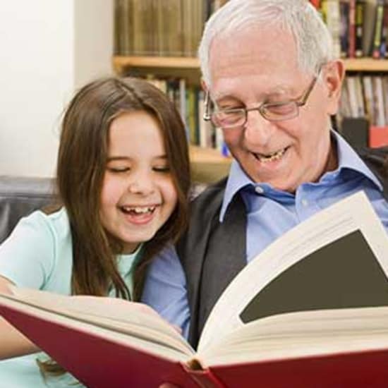 Resident reading to grand kids at West Fork Village in Irving, Texas