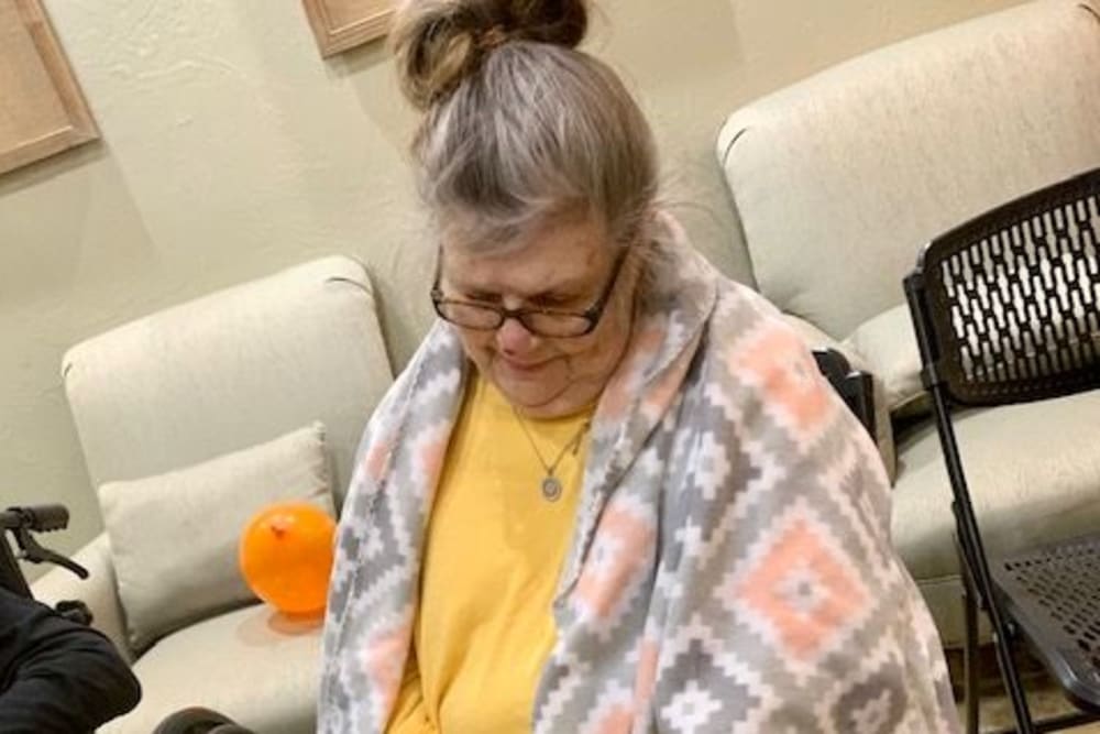 Resident watering plants at Shawnee Memory Care in Shawnee, Oklahoma