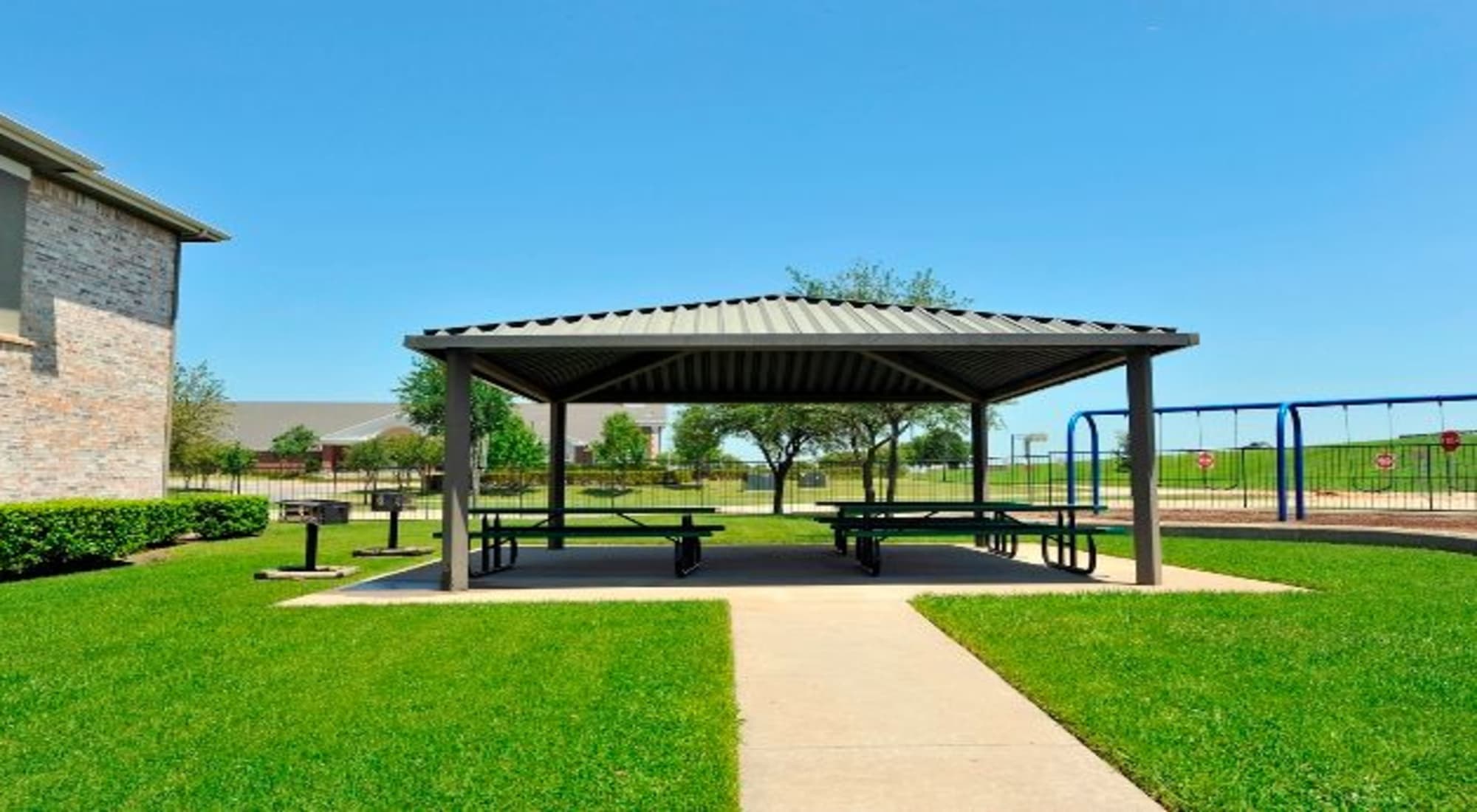 Outdoor community space with pavilion at The Springs of Indian Creek in Carrollton, Texas