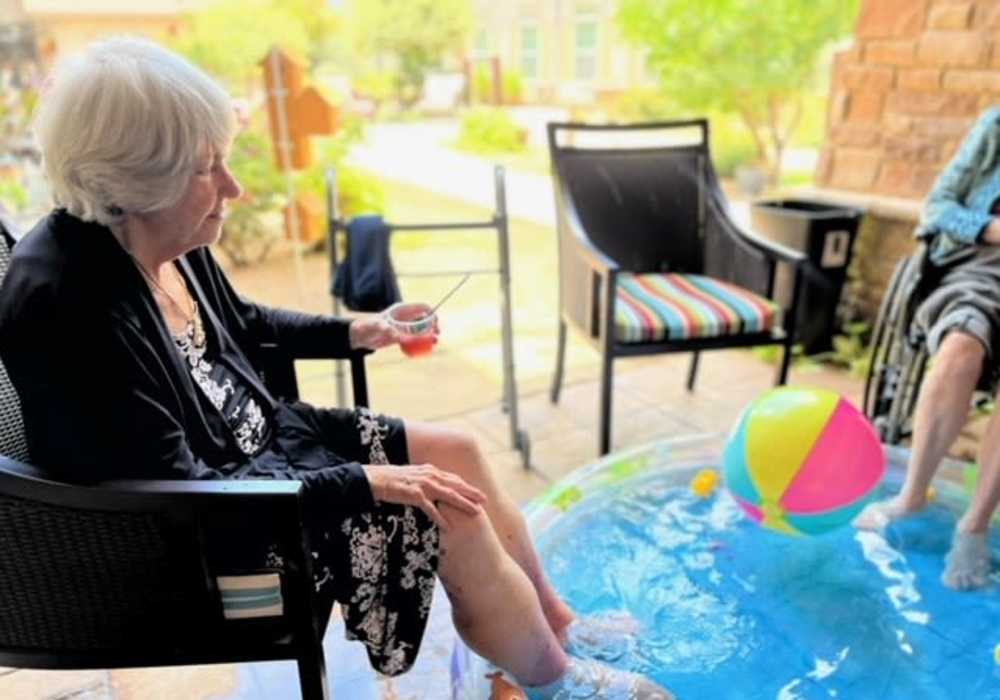 Residents dipping their feet in a pool at Truewood by Merrill, Keller in Keller, Texas