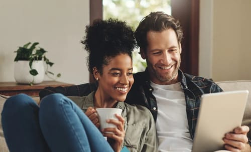 Couple on laptop at 24Hundred Apartments in Oklahoma City, Oklahoma