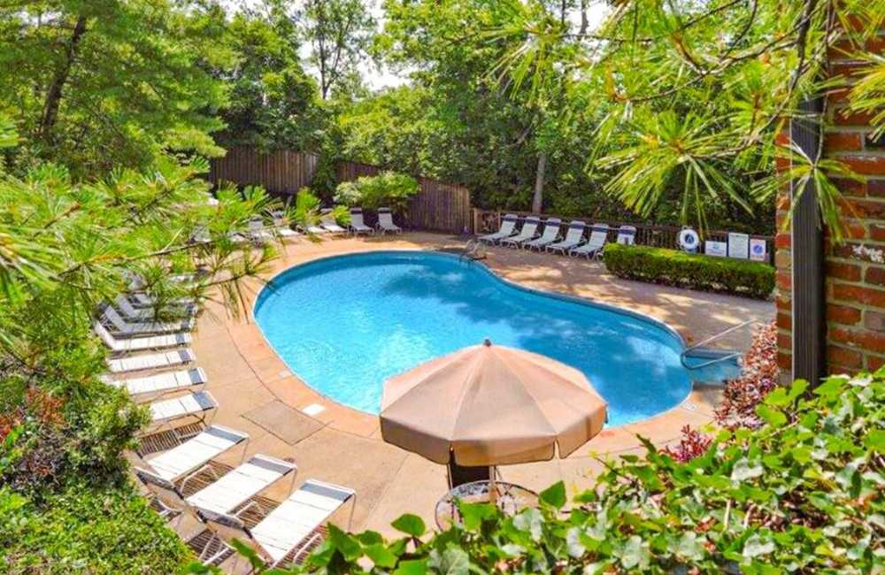 Community swimming pool with lounge chairs at Carriage Court in Cincinnati, Ohio