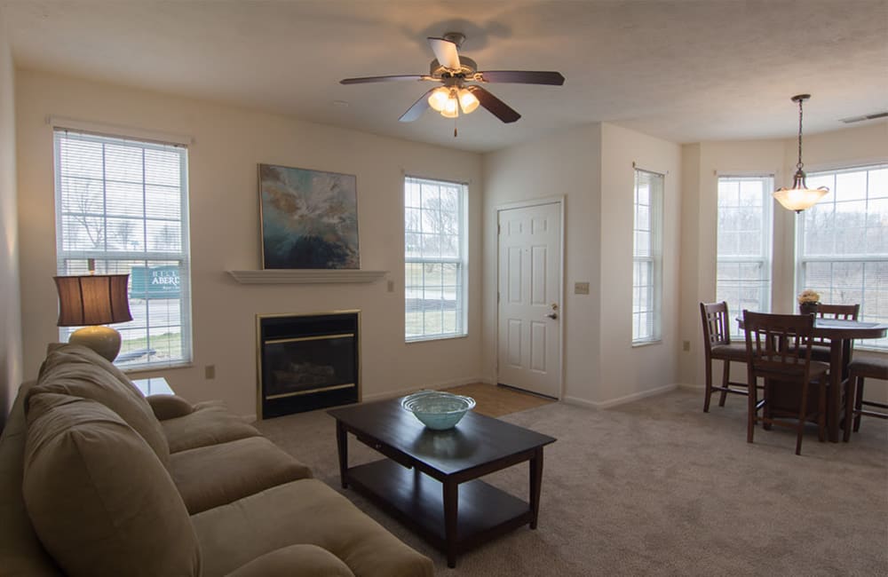 Living room with plank flooring in a model home at Hills of Aberdeen Apartment Homes in Valparaiso, Indiana