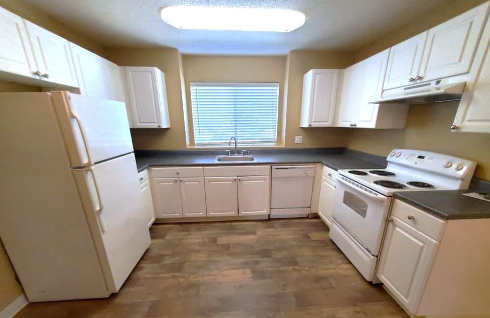 Kitchen with wood-style floors at  River Terrace in Sacramento, California