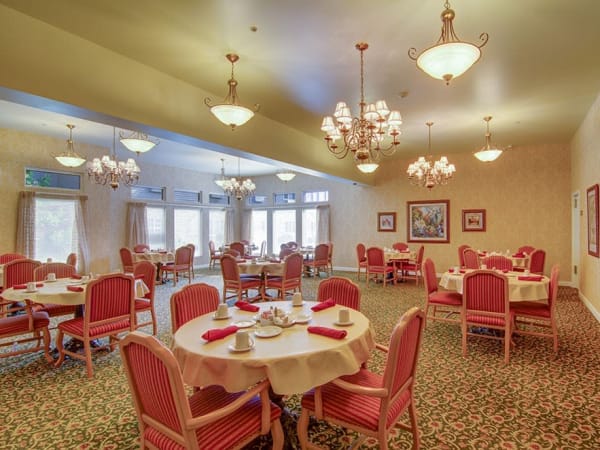 Elegant restaurant-style dining with round tables and comfortable seating at Randall Residence of McHenry in McHenry, Illinois