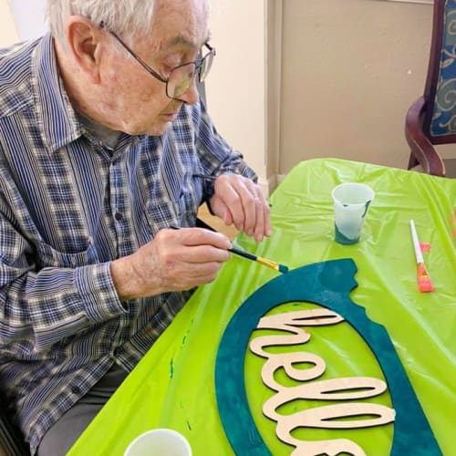 Resident painting at Saunders House in Wahoo, Nebraska