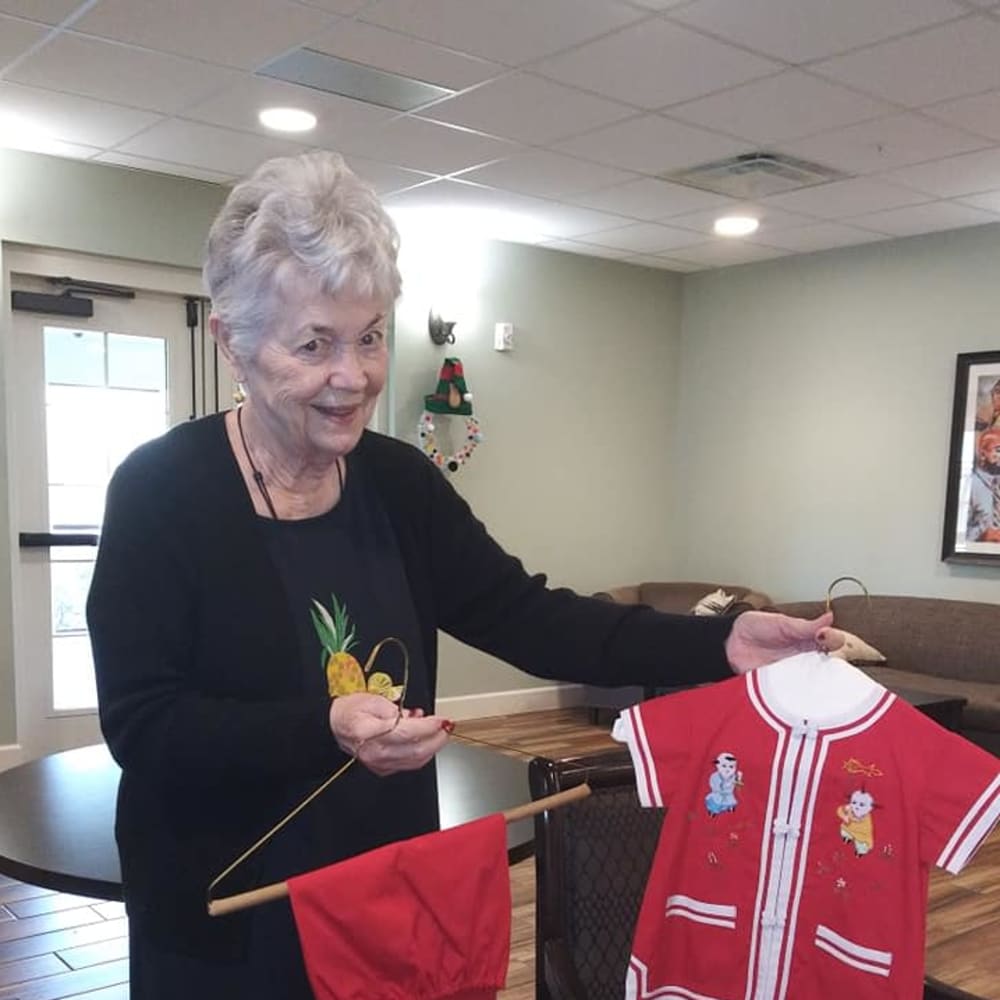 A resident showing off clothes at Inspired Living Kenner in Kenner, Louisiana.