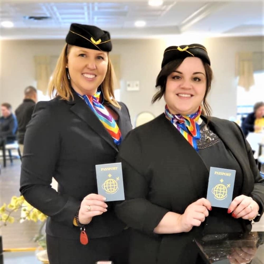 Staff members with a passport at Inspired Living Kenner in Kenner, Louisiana.