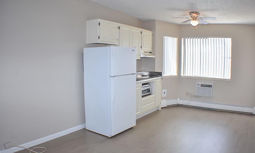 An unfurnished kitchen with a few appliances and a window in a model home at Truckee River Terrace in Reno, Nevada.