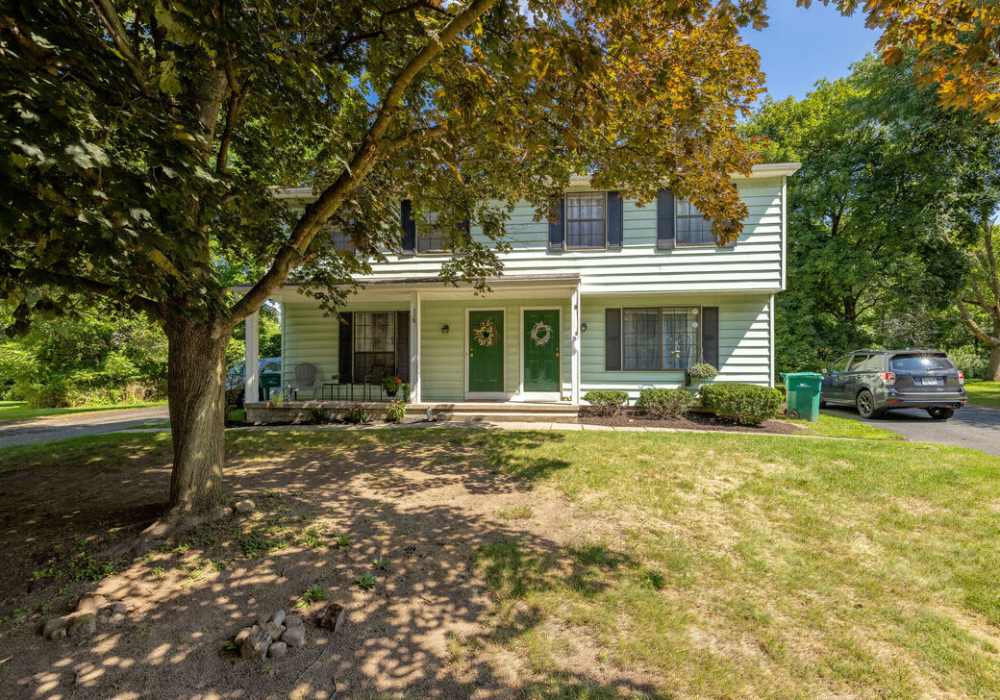 Charming home with green entryway and landscape at Jefferson Manor Townhomes in Fairport, New York