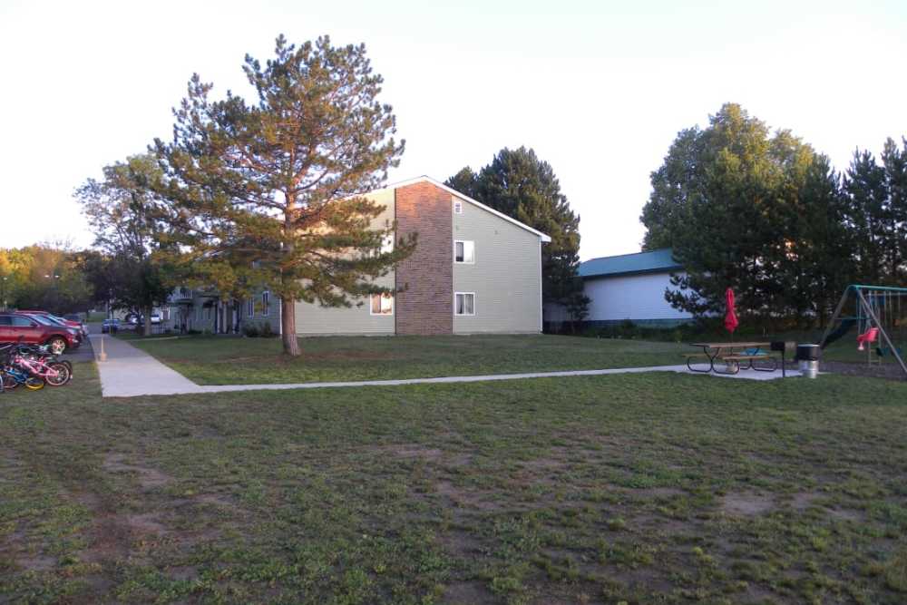 Children playing area with swings at Copper Hills Apartments in Houghton, Michigan,