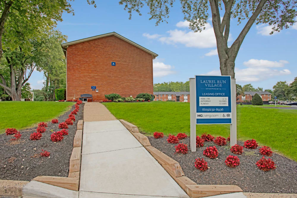 Side view of property with sign of leasing office of Laurel Run Village in Bordentown, New Jersey