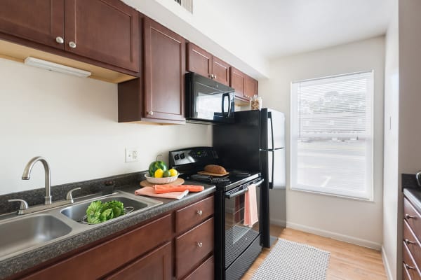 Model kitchen with black appliances at Maple Oaks Estates in Middletown