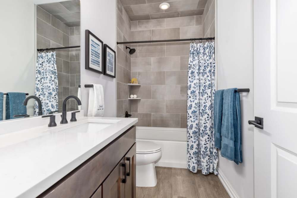 Bathroom with mirror and bathtub at Encore at Heritage Woods in Dexter, Michigan