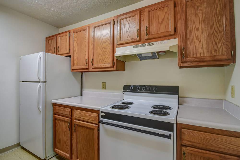Apartment kitchen with fridge and stove at Greene Gables in Ridgeley, West Virginia