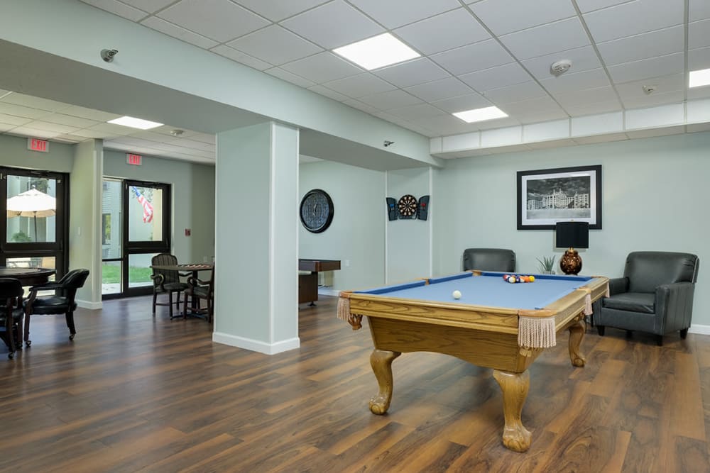 Pool table and darts in the community center at Grand Villa of Clearwater in Clearwater, Florida