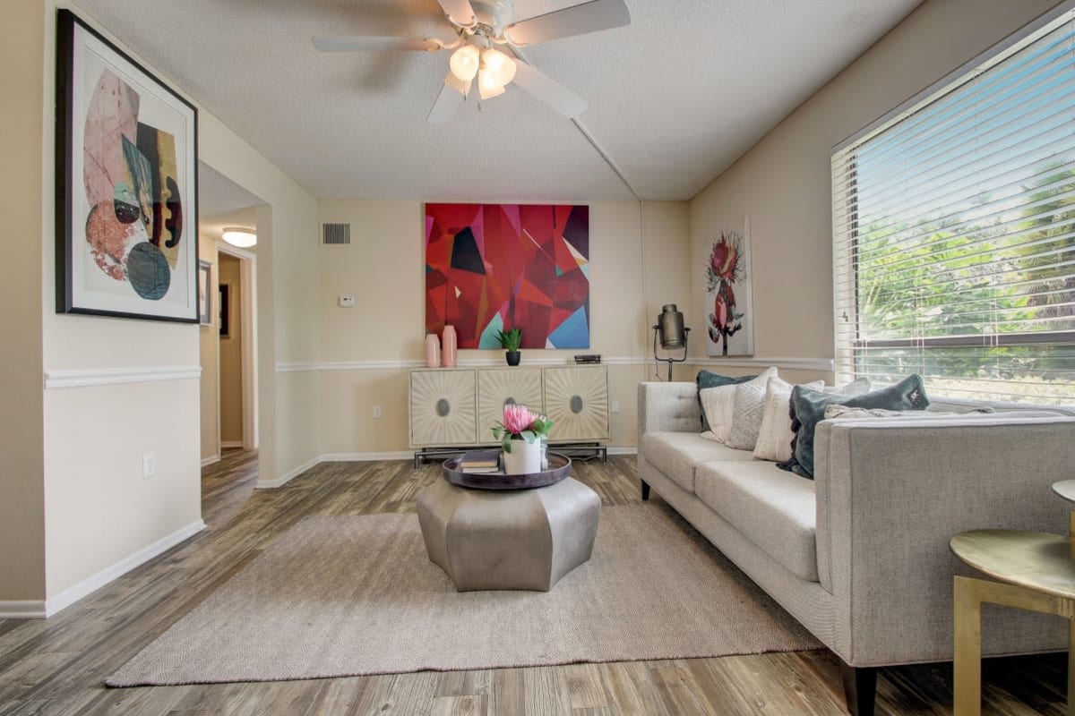 Apartment living room with wood-style flooring at Derby Park Apartments in Daytona Beach, Florida