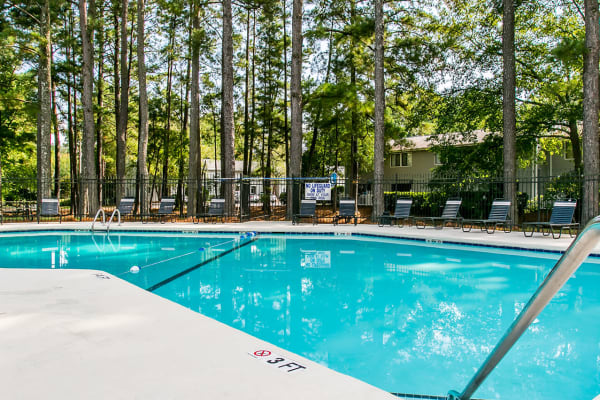 Sparkling swimming pool in a tranquil wooded setting at Forestbrook Apartments and Townhomes in West Columbia, South Carolina