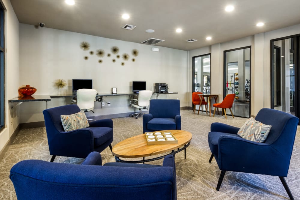 Business center with seating area in community lounge at Marquis at Barton Trails in Austin, Texas