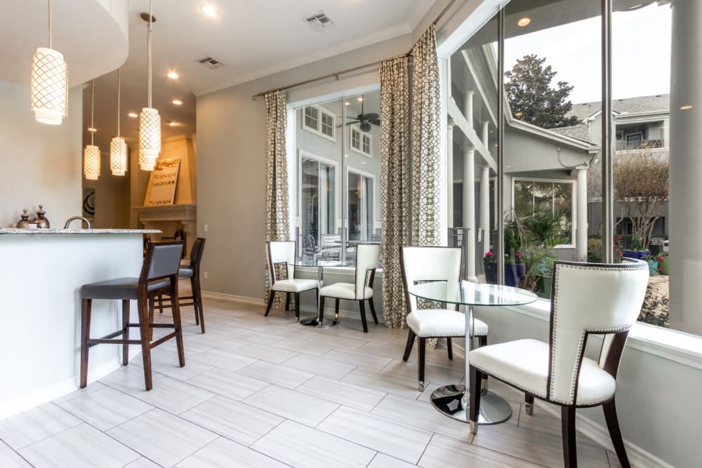 Community clubhouse kitchen and dining area with large windows at Marquis at Stonegate in Fort Worth, Texas